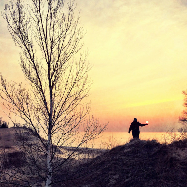 A Labrys guest holding the Lake Michigan sunset